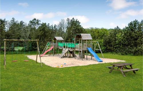 a park with a playground with a slide and a bench at Beautiful Home In Ulfborg With Wifi in Husby