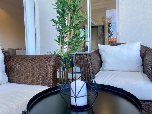 a coffee table with a plant on top of it at Appartement Vue Panoramique sur la siesta plage WELCOME STAY in Mohammedia
