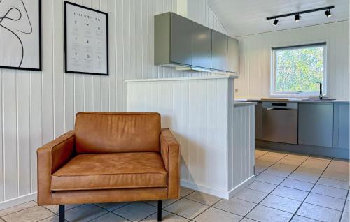 a brown chair in a kitchen with a counter at Holiday Home Nørtvedvej Strandby Denm in Strandby