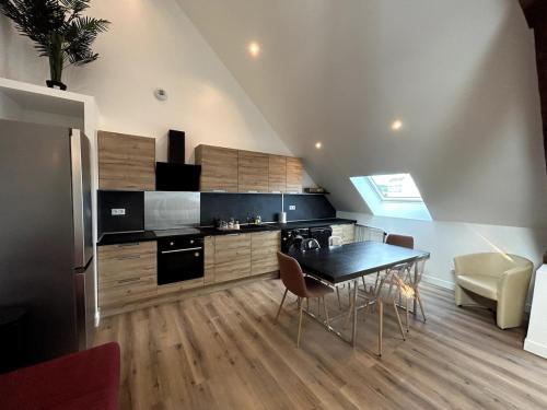 - une cuisine avec une table et des chaises noires dans la chambre dans l'établissement Modern renovated apartment #8 with 7pers mezzanine, à Cherbourg en Cotentin