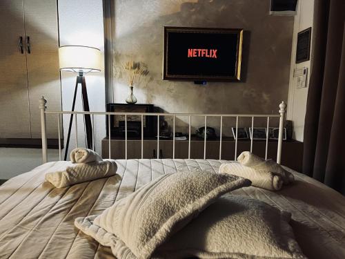 a bedroom with a bed with two pillows on it at Riverside Apartment in Bitola