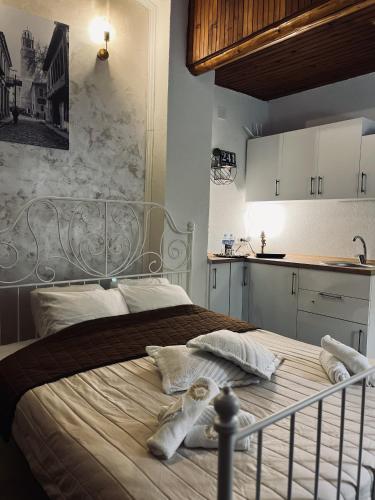 a bedroom with a bed with towels on it at Riverside Apartment in Bitola