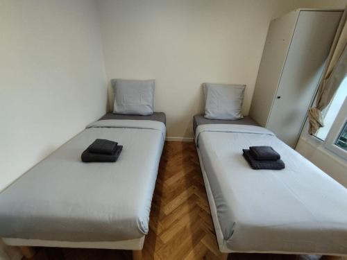 two beds in a small room with at Très bel appartement à Paris et La Défense in La Garenne-Colombes