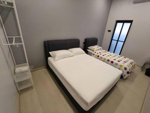 a small bedroom with a bed and a window at Room 2 U Hostel & Guest House in Muar
