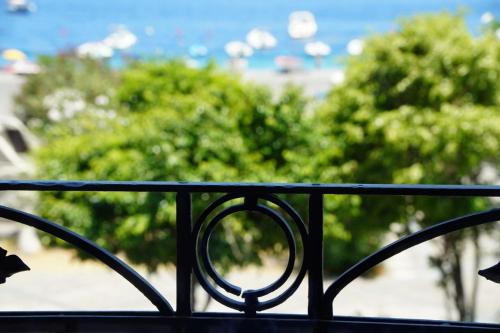 a black metal railing with trees in the background at Case Vacanze Bedda Iole in Canneto