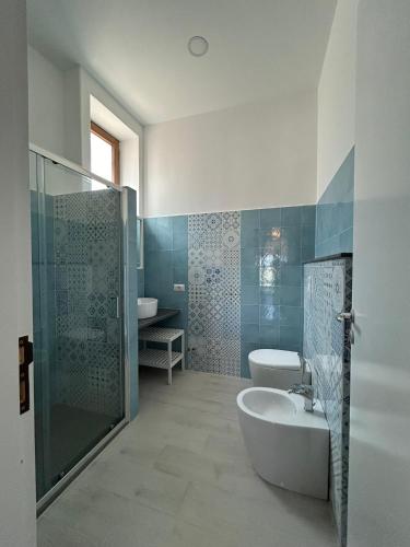 a bathroom with a tub and a sink and a shower at Case Vacanze Bedda Iole in Canneto