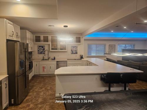 a kitchen with white cabinets and a large island in it at Casa Del Lago Camping, Jetski docks, Personal dock in Moses Lake