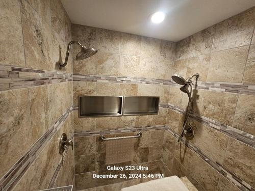 a tiled bathroom with a shower with a sink at Casa Del Lago Camping, Jetski docks, Personal dock in Moses Lake