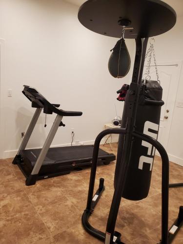 a gym room with a treadmill and a bike at Casa Del Lago Camping, Jetski docks, Personal dock in Moses Lake