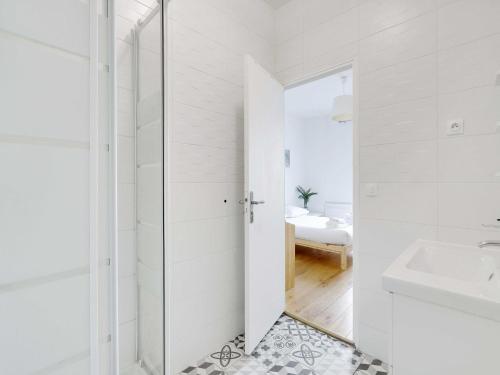 a white bathroom with a sink and a mirror at Spacious Studio - 2P - Levallois-Perret in Levallois-Perret