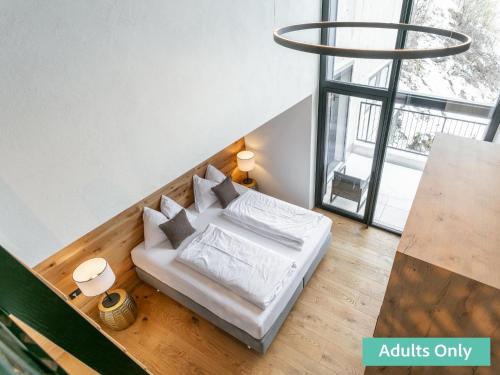 a white couch in a room with a large window at Adult Only Superior Suite in Niederhof