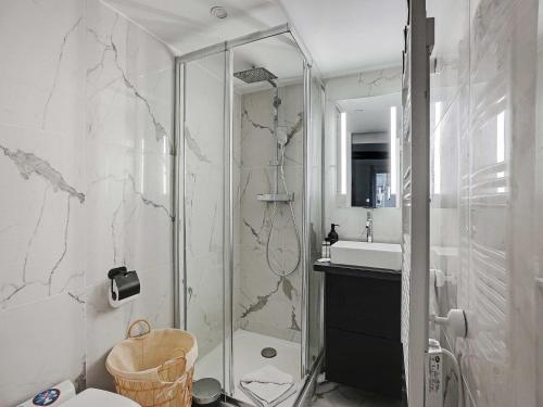 a bathroom with a shower and a toilet and a sink at Charming studio near les Halles - Mobility lease in Paris