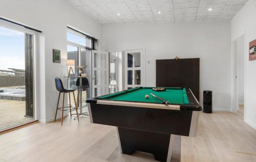 a pool table in a living room with a pool at Awesome Home In Odder With Sauna in Odder