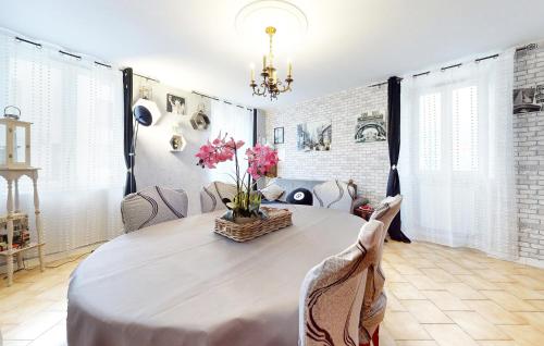a dining room with a table with flowers on it at 2 Bedroom Gorgeous Home In Vignory in Vignory