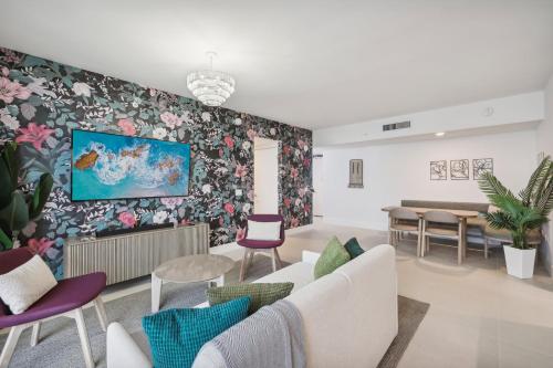 a living room with a couch and a floral wall at Stunning Lux 2 Bed 2 Bath with Panoramic View from Balcony in Miami