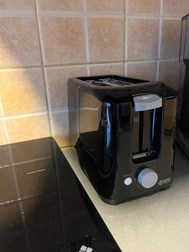 a black coffee maker sitting on a kitchen counter at Guesthouse Vladimir & Ana in Pančevo