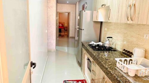 a kitchen with a sink and a counter top at Downtown apartment in Agadir