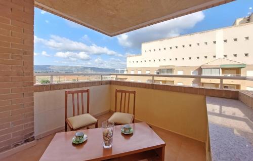 a table and chairs on a balcony with a view at Amazing Apartment In Oropesa Del Mar in Oropesa del Mar