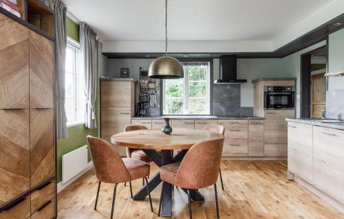 a kitchen with a wooden table and chairs at 3 Bedroom Awesome Home In Stöllet in Stöllet