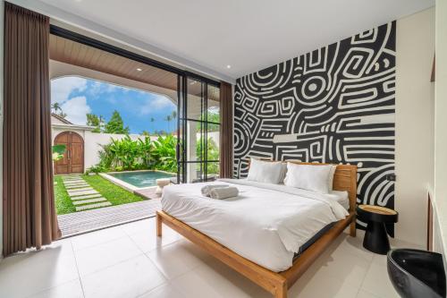 a bedroom with a bed and a large window at Brand New 4BDR Villa - Cozy and Stylish - CANGGU with Breathtaking Stunning View in Seminyak