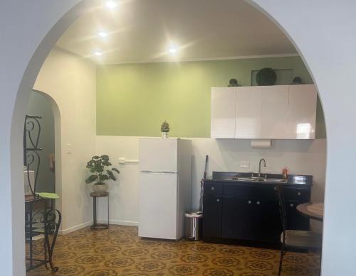 a kitchen with a white refrigerator and a sink at 310Guest-House La Vida in San Juan