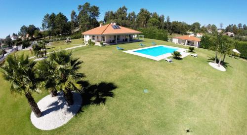 an aerial view of a house with a swimming pool at Villa Vieira in Alvarães