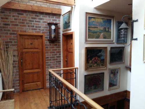 a hallway with paintings on a brick wall at U Anny Šmejdířky in Nymburk