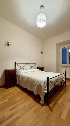 a bedroom with a bed and a chandelier at Casa del Conte in Canino