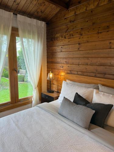 a bedroom with a bed with a wooden wall at Jacaranda Cottage 5 min by Train or 7 min drive to Parramatta City in Wentworthville
