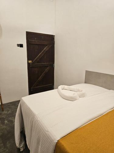 a bed with two towels on it in a room at Muthu Hiriketiya in Dickwella