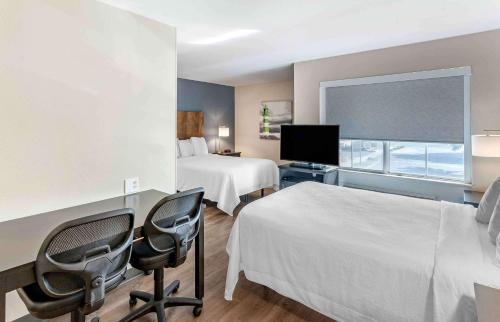 a hotel room with two beds and a flat screen tv at Extended Stay America Premier Suites - San Jose - Airport in San Jose