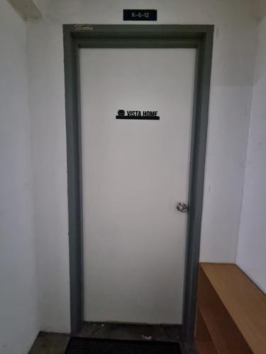 a white door with a sign on it at Vista Home in Kajang
