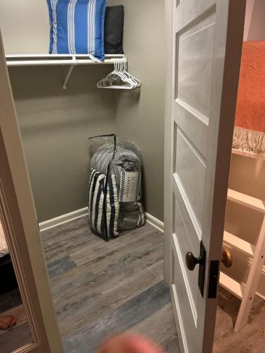 a room with a closet with a backpack on the floor at Cozy Portland Retreat in the Heart of Hollywood in Portland