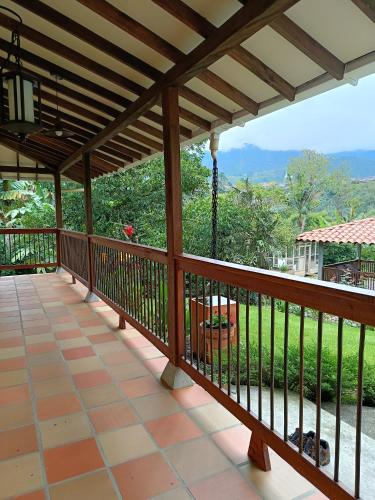 a wooden deck with a view of a garden at Finca MonteSer in Jardin
