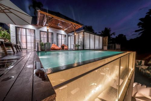 a swimming pool in front of a house at Exclusive New Villa in Ubud - 2BDR, Massive Pool - Ultimate Luxury in Ubud