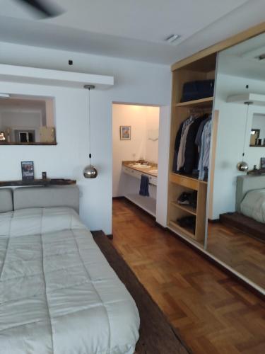 a bedroom with a large bed and a bathroom at The House you're looking for in Córdoba