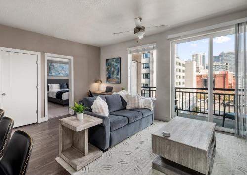 a living room with a couch and a large window at Boutique 1BR near Convention Center - Pool,Htub,Gym in Salt Lake City