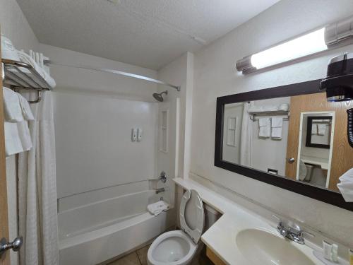 a bathroom with a sink and a toilet and a mirror at Quality Inn in Johnstown