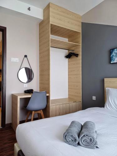 a bedroom with a bed and a desk and a chair at Family Friendly Unit in K Avenue in Donggongon
