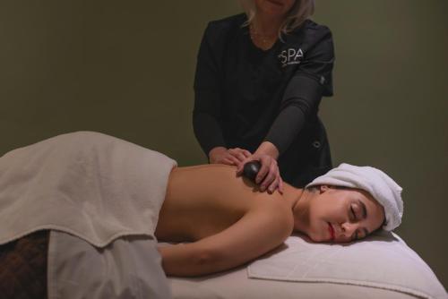 a woman is getting a massage from a spa practition at Hotel Washington in Washington