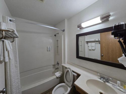 a bathroom with a sink and a toilet and a mirror at Quality Inn in Johnstown