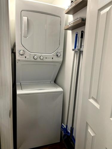 a white washer and dryer in a small room at The Hive - Unique Themed Getaway in Billerica