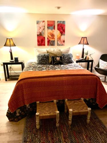 a bedroom with a large bed with two tables and two lamps at Calm and Private room in Portland
