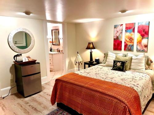 a bedroom with a large bed and a mirror at Calm and Private room in Portland