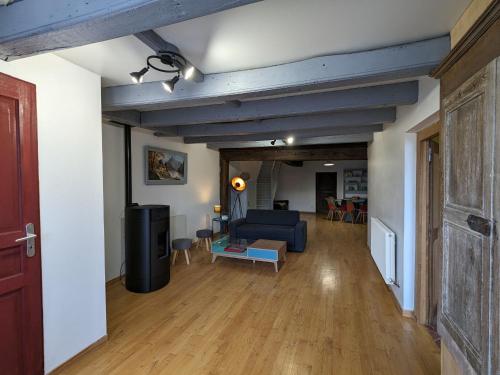 a living room with a blue couch and a table at Gîte rénové à Mauvages avec jardin, BBQ et WIFI - FR-1-585-167 in Mauvages