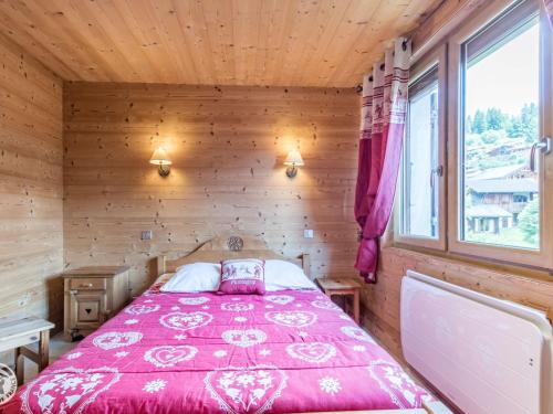 a bedroom with a bed in a wooden cabin at Chalet cosy aux Gets avec parking privatif - FR-1-671-279 in Les Gets