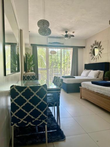 a living room with a bed and a table and chairs at 215 Carola B - Pico de Loro in Cutad