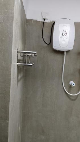a hair dryer on a wall in a bathroom at Kumara villa in Hikkaduwa