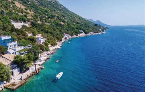 an aerial view of a beach with a boat in the water at Two-Bedroom Apartment In Ratac in Orasac