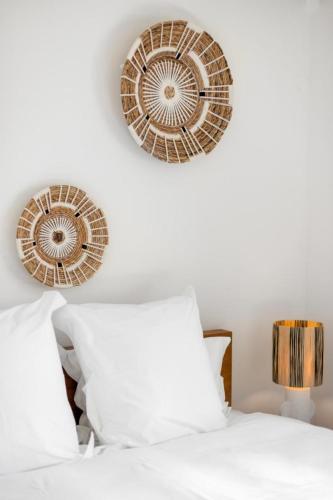 a bedroom with a bed with two plates on the wall at 3-bedrooms Villa 5min from Orient Bay in Cul de Sac